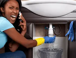 Emergency plumbing repair for a leaking sink drain under a bathroom vanity in Louisville, KY
